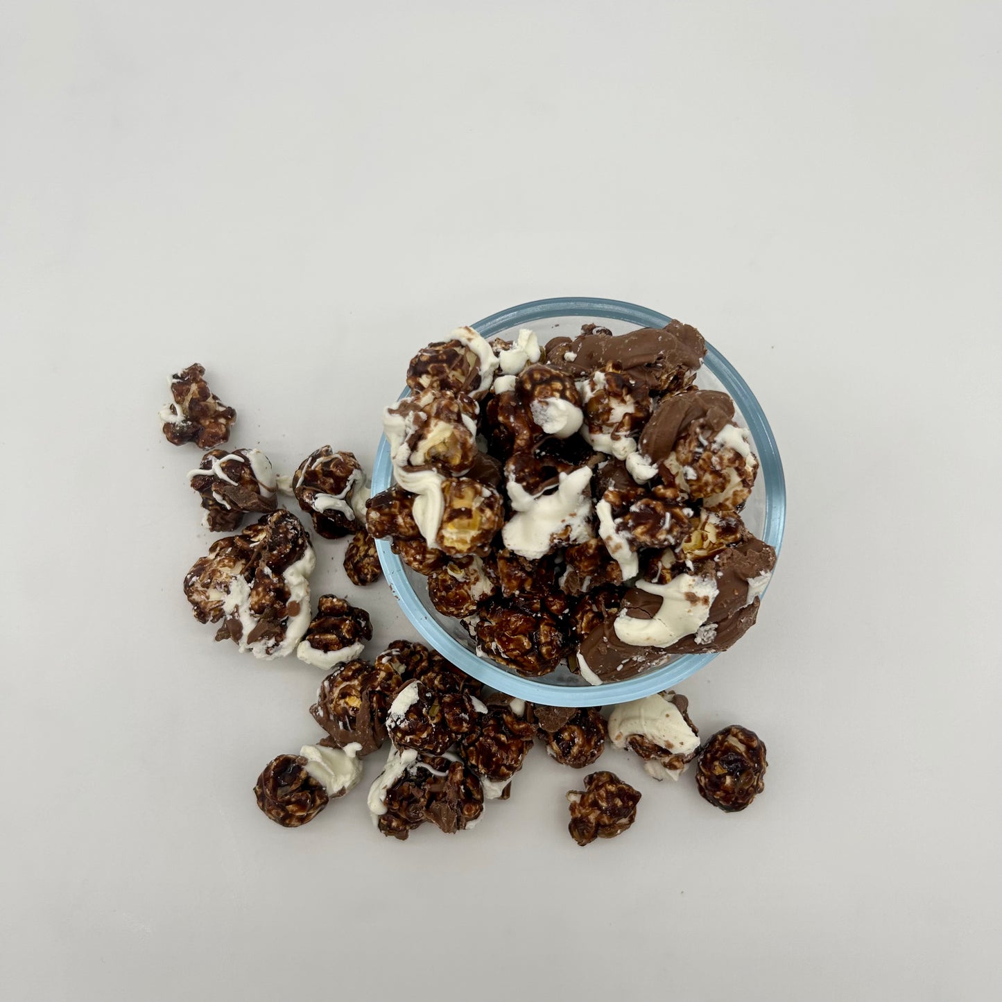 Chocolate coated popcorn drizzled with white and milk chocolate